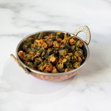 A copper bowl is with air fried okra.