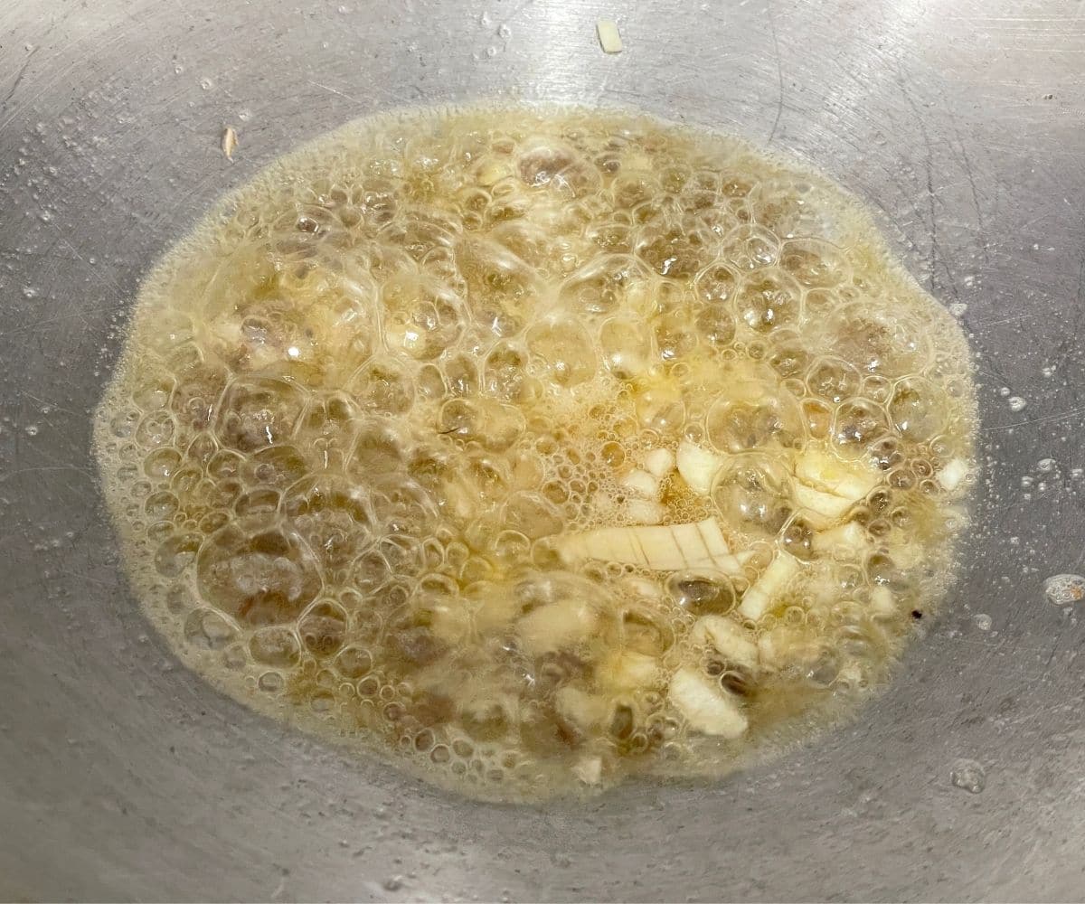 A pan is with vegan butter and spices over the heat.