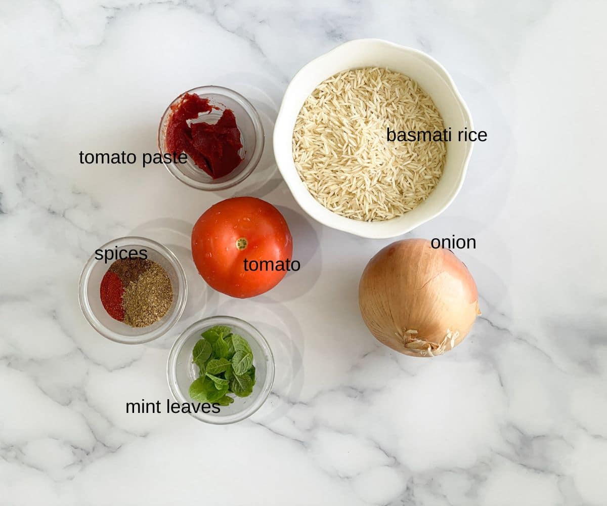 Tomato rice ingredients are on the table.