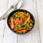 A black color bowl is with vegan Jalfrezi.