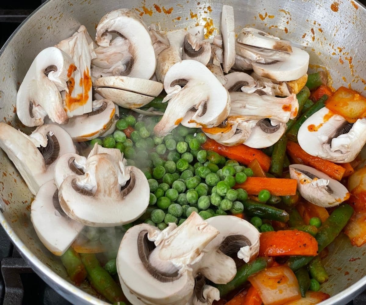 A pan is with vegetables to make jalfrezi recipe.