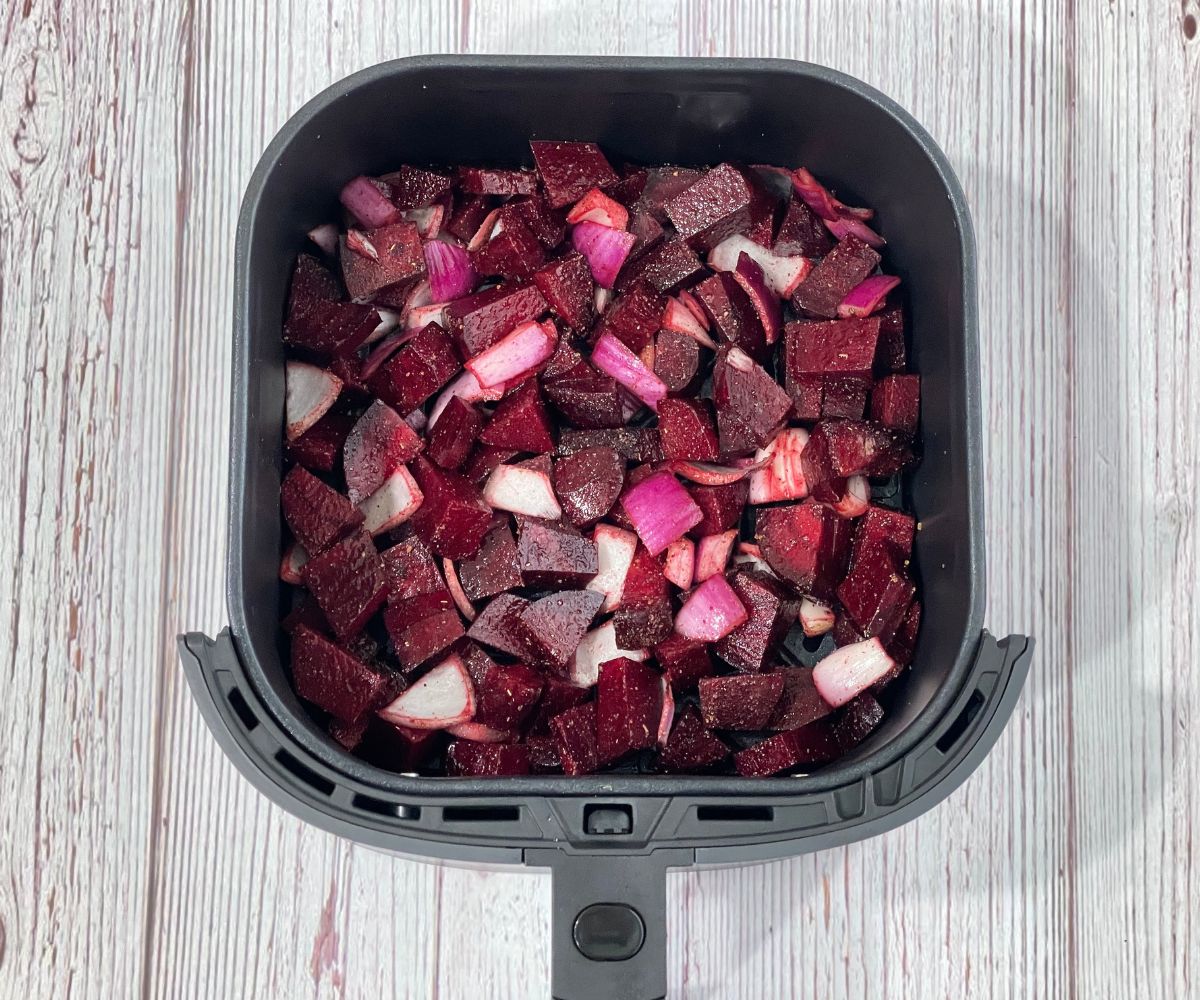Air fryer basket is with beets mixture.