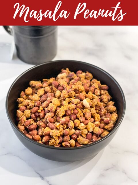 Bow of masala peanuts and tea is on the table.