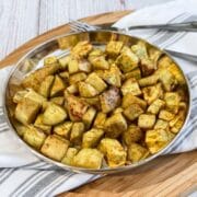 A plate is with air fried sweet potato chunks.