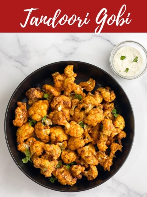 A plate of tandoori cauliflower is on the table.