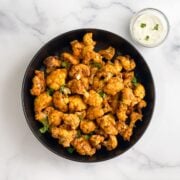 A plateful of tandoori gobi is on the table.