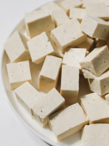 A plate is with cubed tofu.