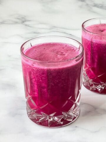 A glass of pitaya juice is on the table.