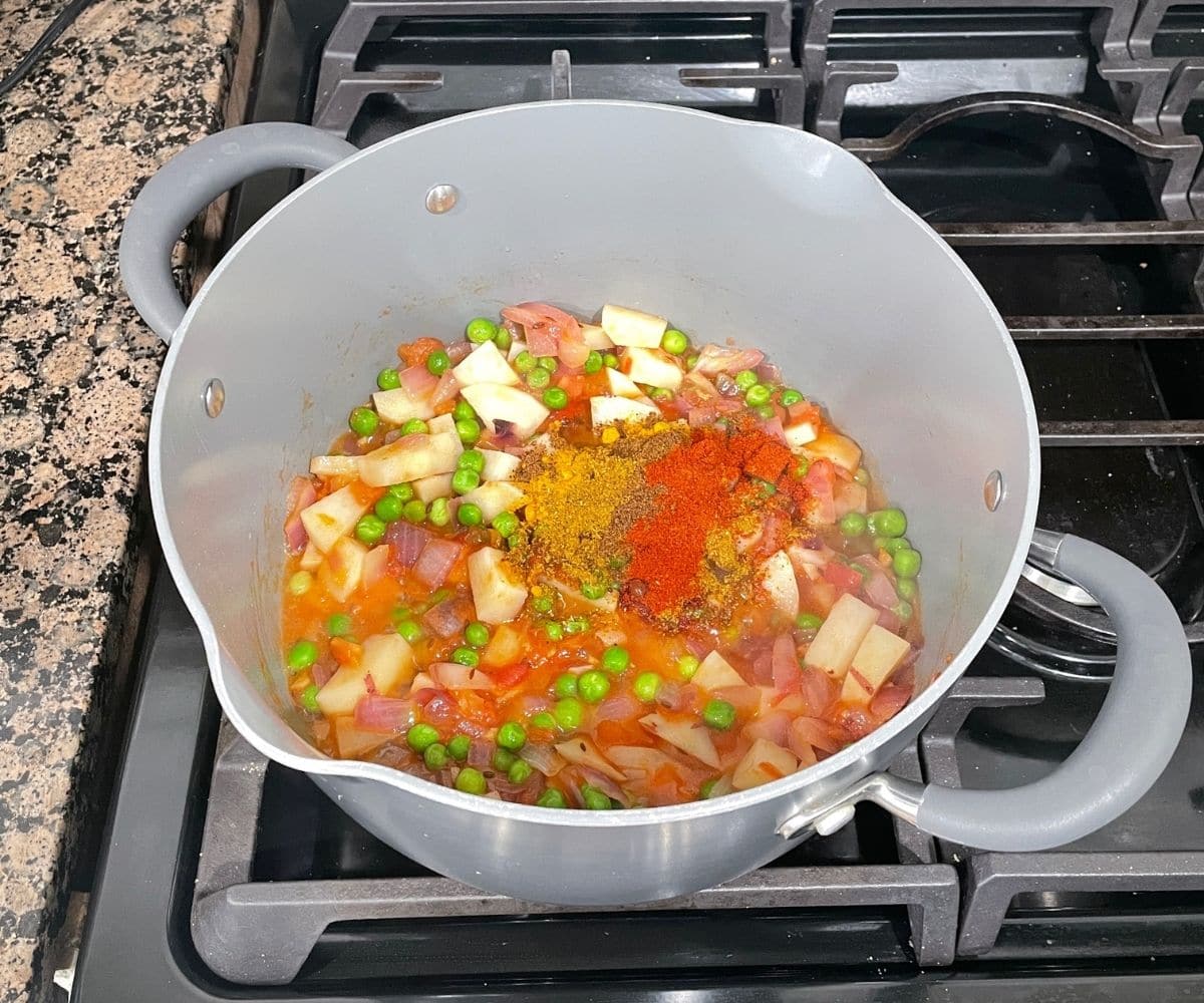 A pan is with veggies and spices.