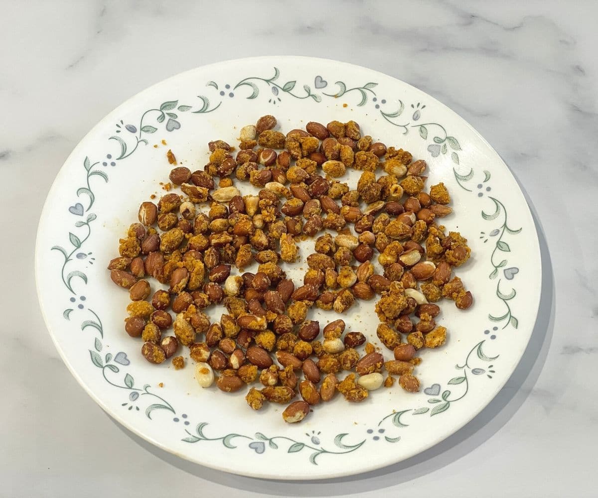 A plate is with masala groundnuts.