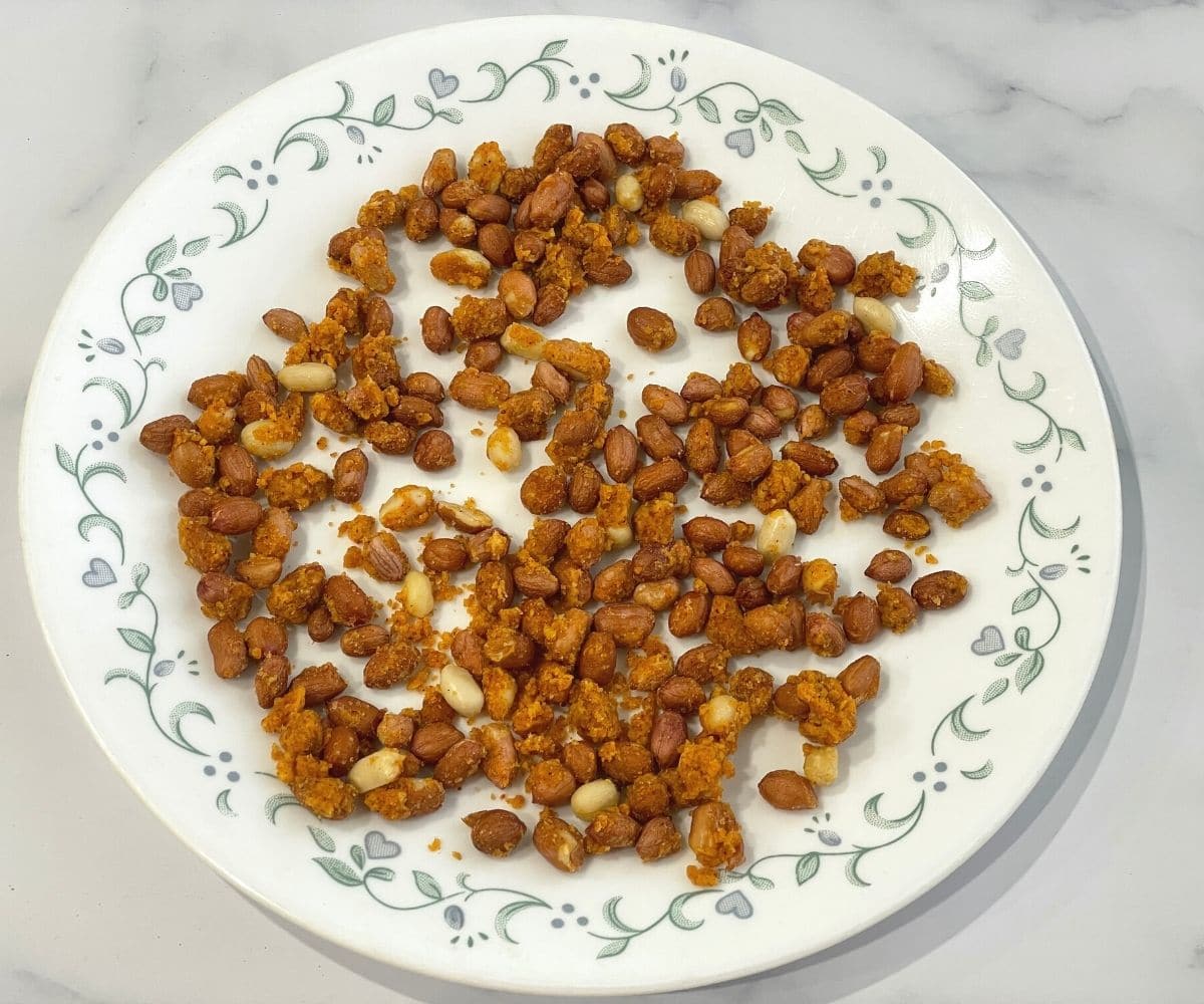 A plate is with masala peanuts mixture.