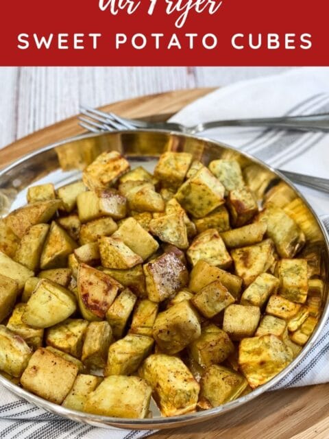 A plate of air fryer sweet potato cubes are on the table.