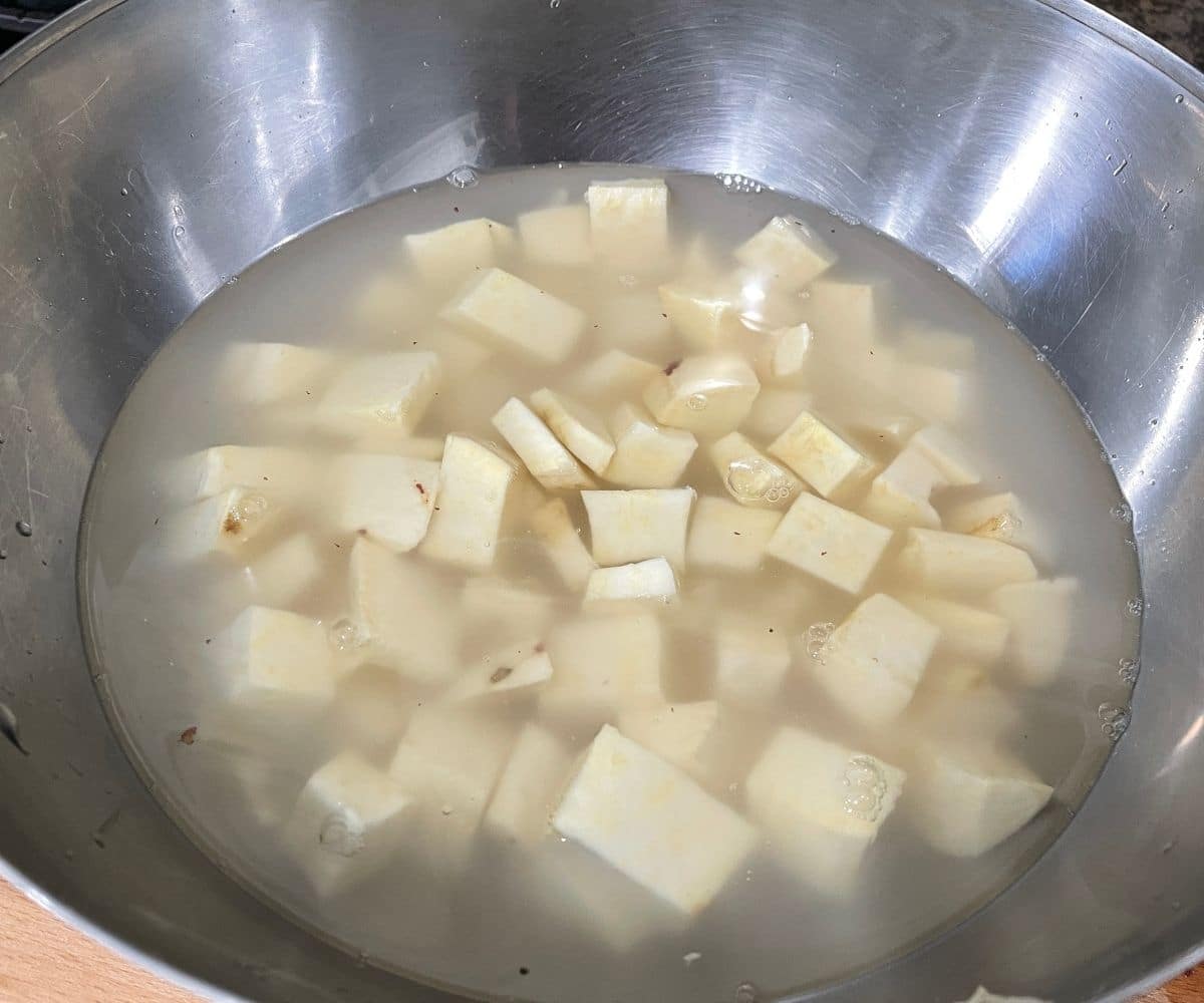 sweet potato cubes are inside the bowl of water.