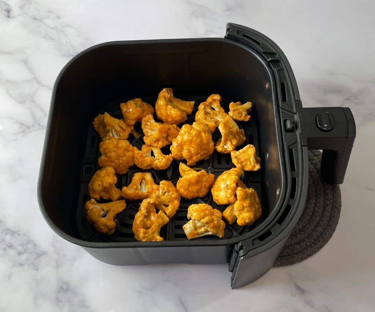 Air fryer basket is with tandoori gobi.