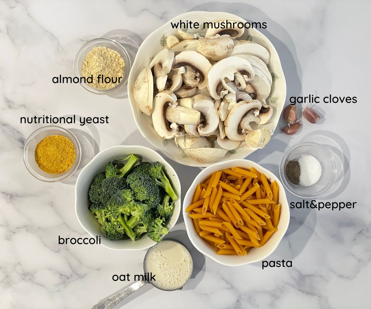 broccoli and mushroom pasta ingredients are placed on the table.