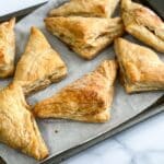 Air fried apple turnovers are placed on the baking tray.