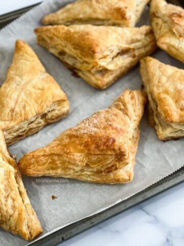 Air fried apple turnovers are placed on the baking tray.