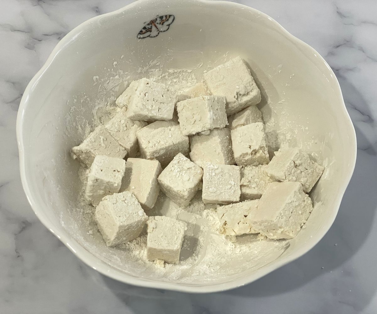 Bite sized tofu cubes are inside the large bowl.
