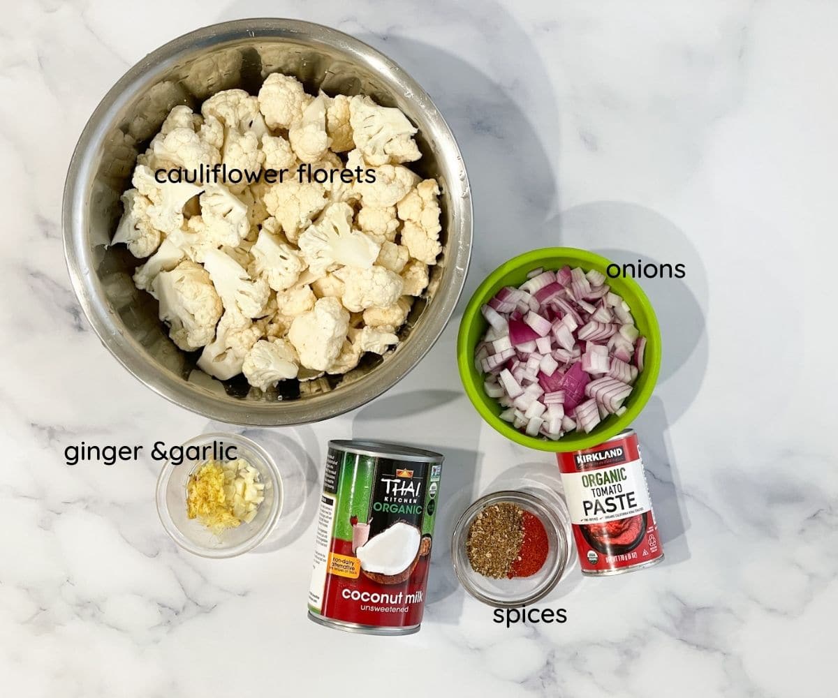 Cauliflower curry ingredients are on the table.