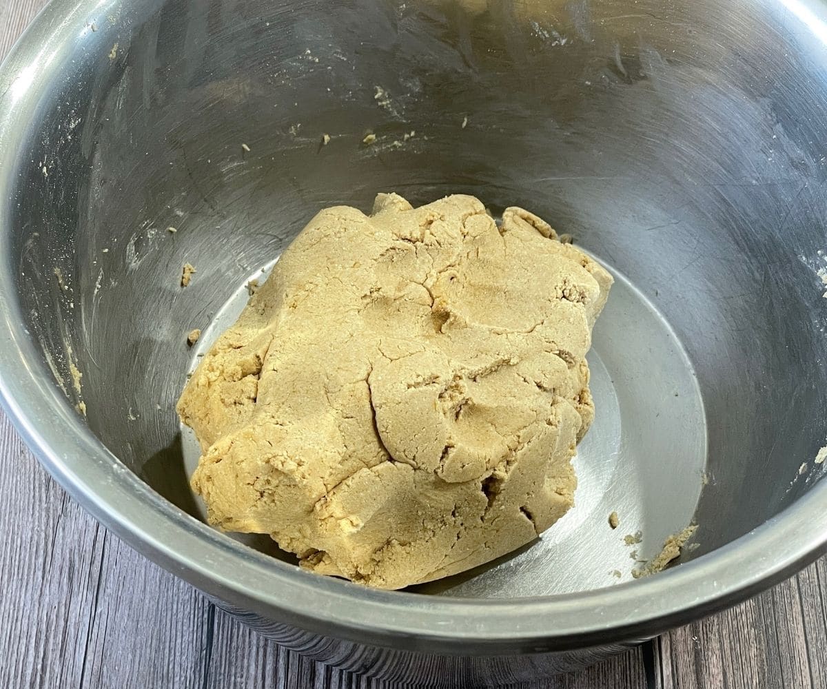 A bowl is with quinoa flour roti dough.