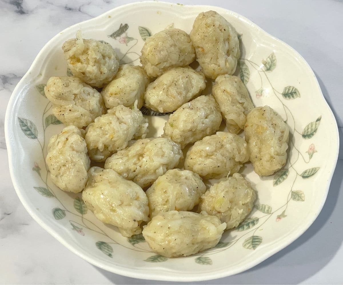 A plate is with cylinder shaped tater tots.