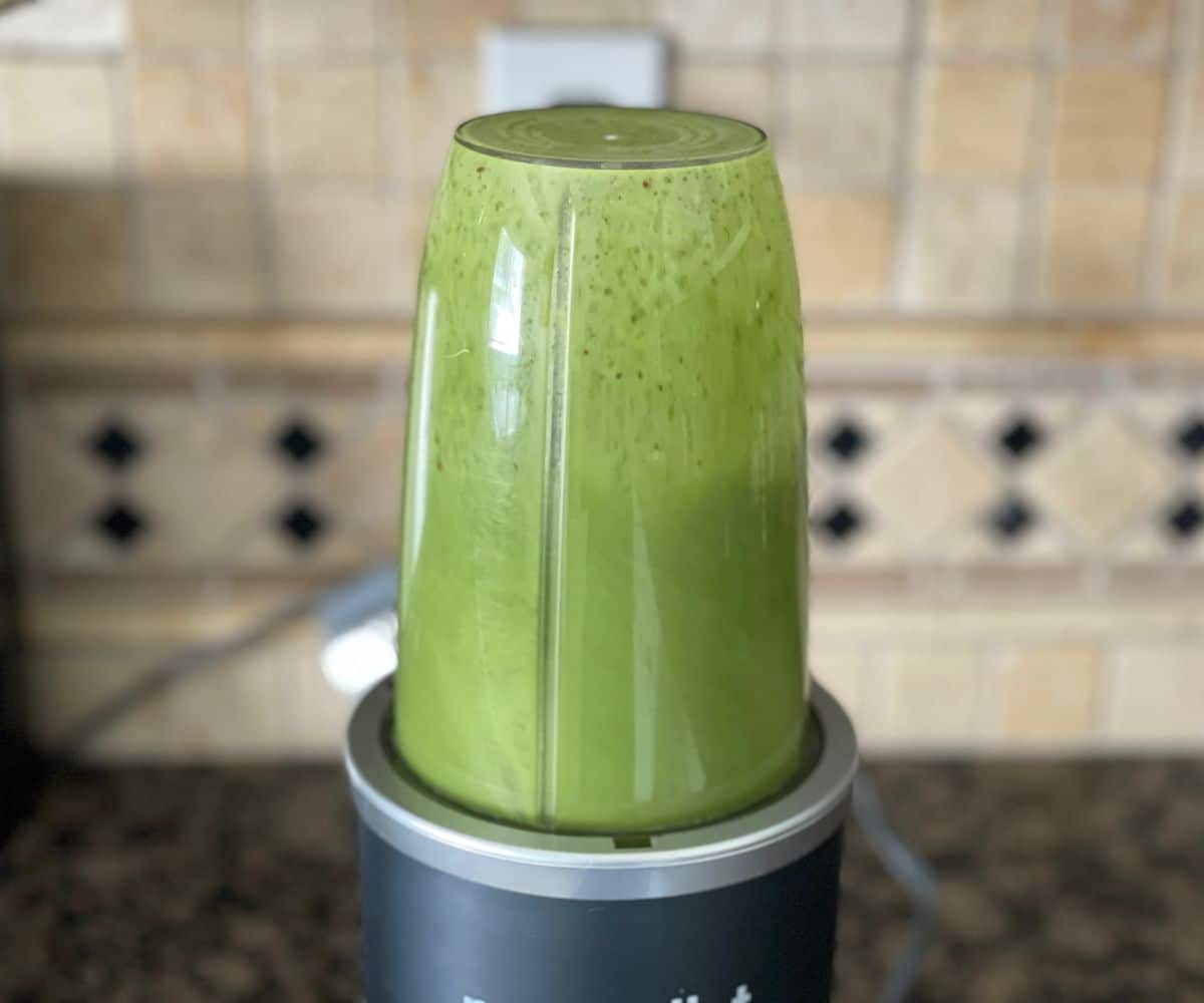 A nutri bullet blender is with mint juice.