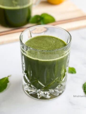 A glass of mint juice is on the table.