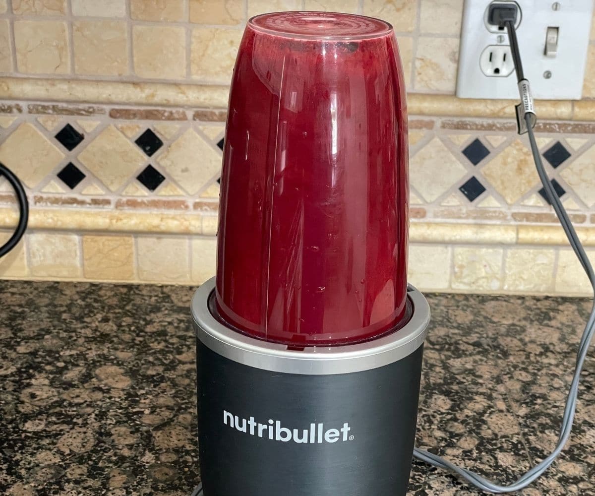A blender is making mulberry juice.