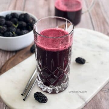 A glass is filled with mulberry juice.