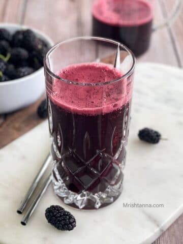 A glass is filled with mulberry juice.