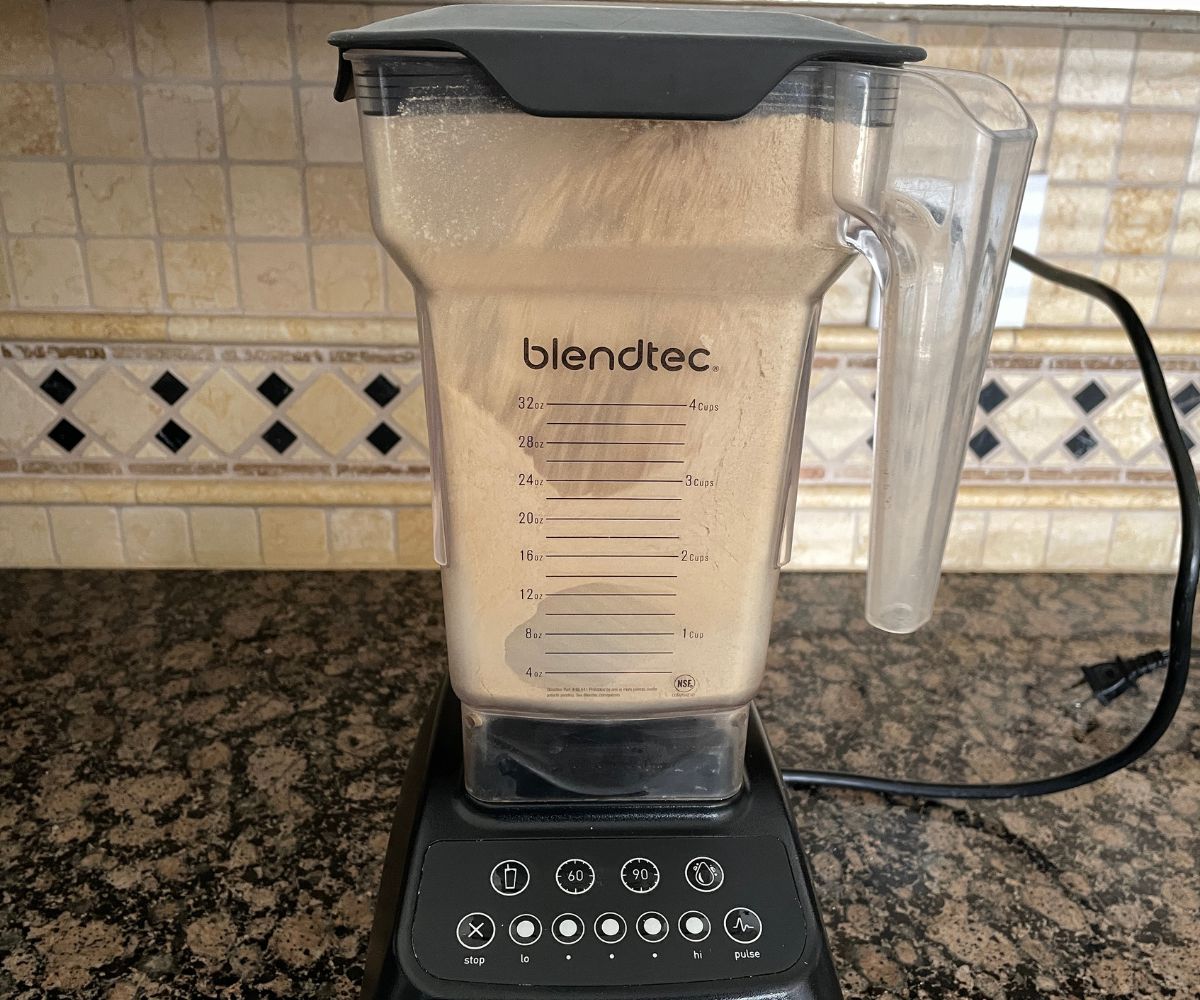 A blender is powdering the roasted quinoa.