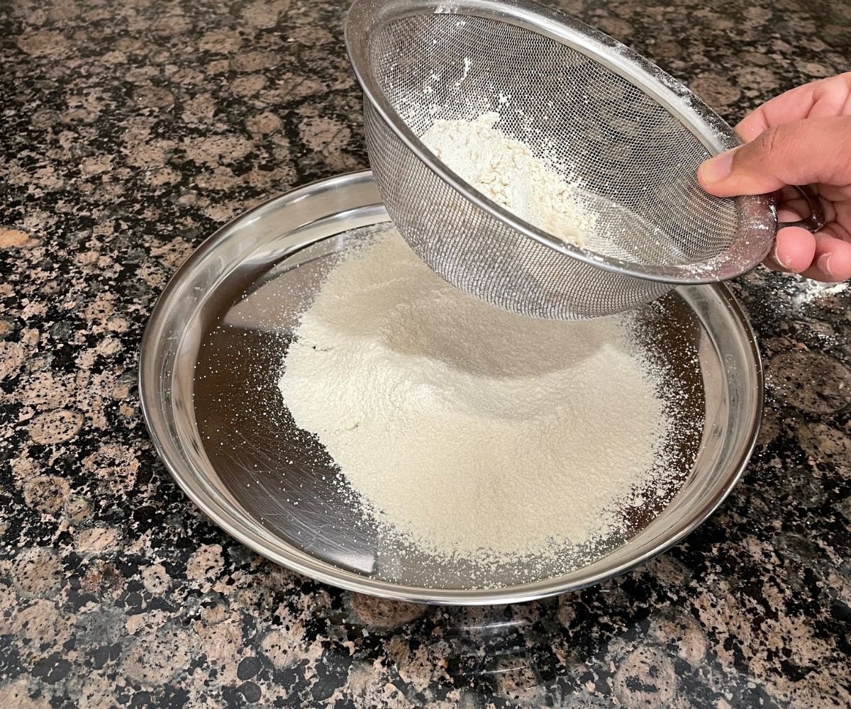 Sifting quinoa flour on the steel plate.