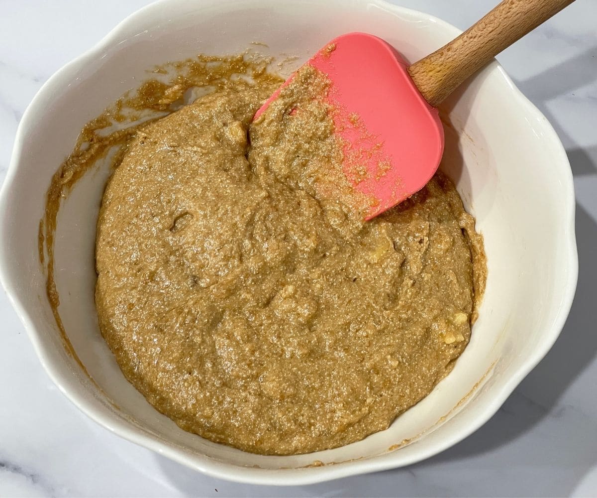 A bowl is with gluten free vegan banana muffins batter.