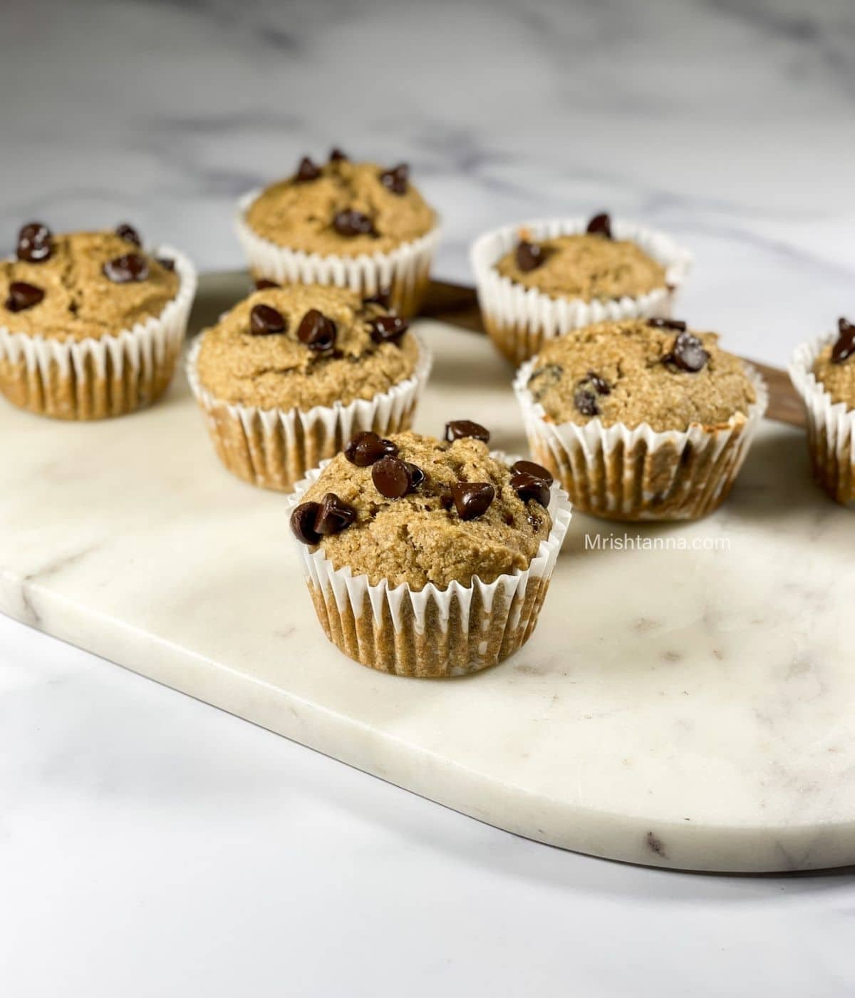 Vegan banana quinoa muffins are on the white board.