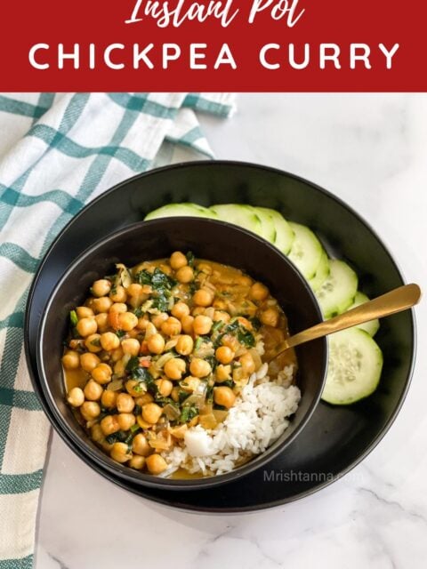 A bowl of Instant pot chickpea curry is on the plate with sliced cucumbers.