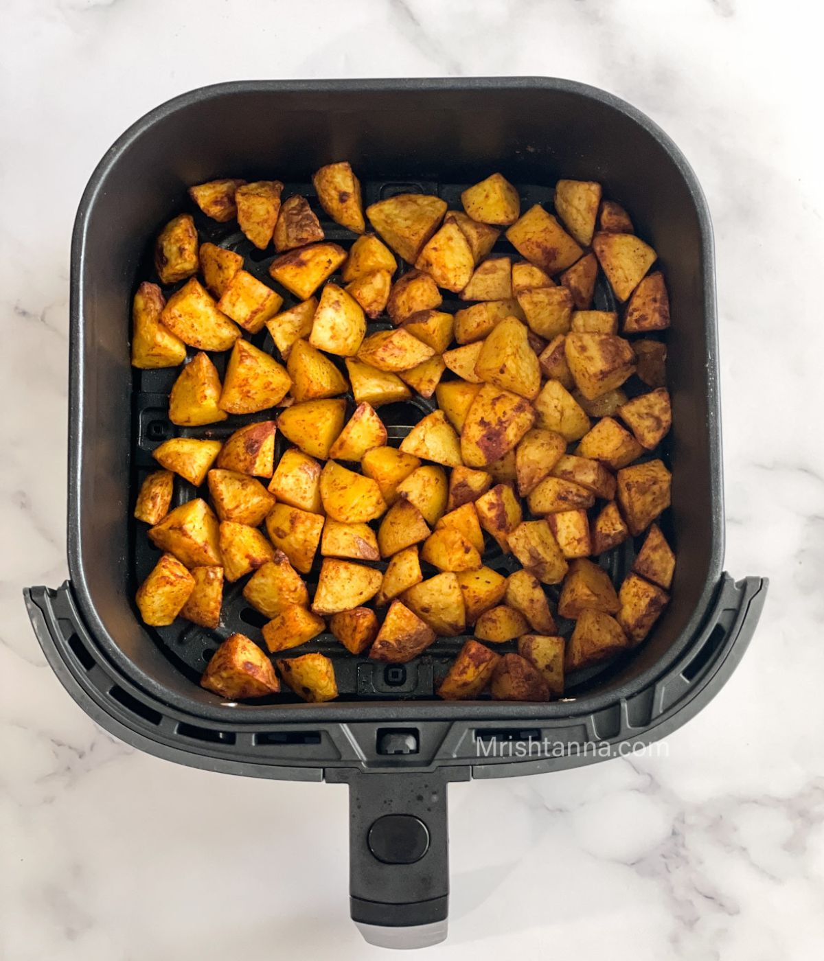 head shot of air fryer potato cubes.