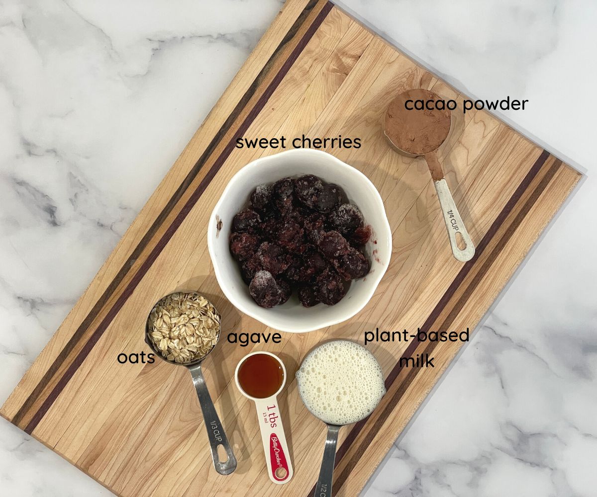 Cherry chocolate smoothie ingredients are on the counter top.