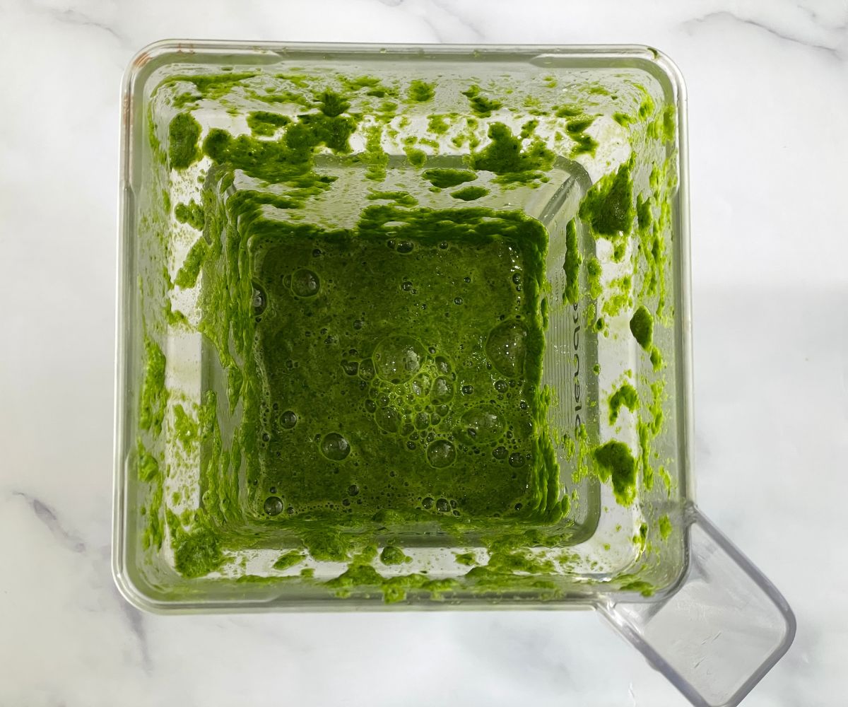 A blender is with spinach puree.