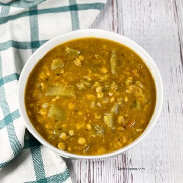 A bowl of lauki chana dal is on the table.