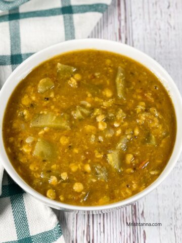 A bowl of lauki chana dal is on the table.