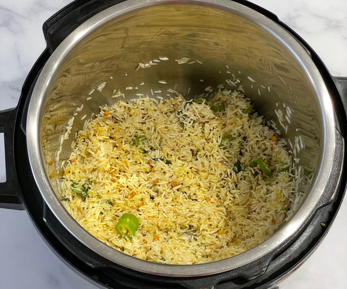 An instant pot is with spices., salt and basmati rice.