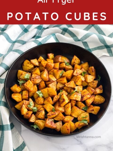 A plate is filled with air fryer diced potatoes.