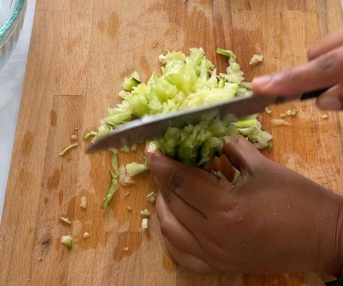 Close up of chopping cucumber shot.