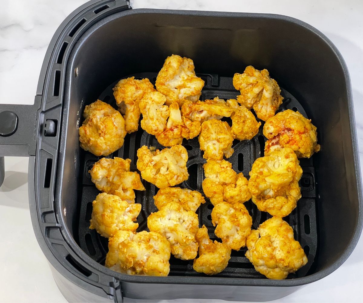 The air fryer basket is coated with coated cauliflower 65 bites.