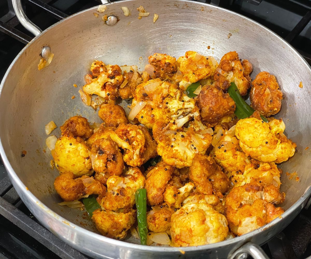 A pot is with an air fryer cauliflower 65 and masala.
