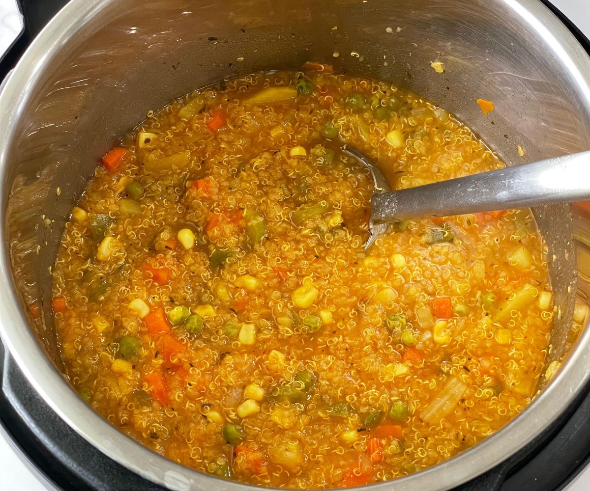 An instant pot is filled with quinoa vegetable soup.
