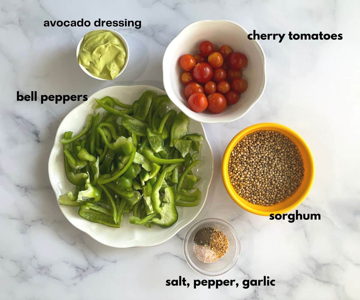 Sorghum salad ingredients are on the white surface.