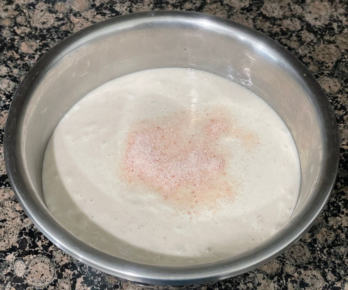 A bowl is with adai dosa batter and salt.