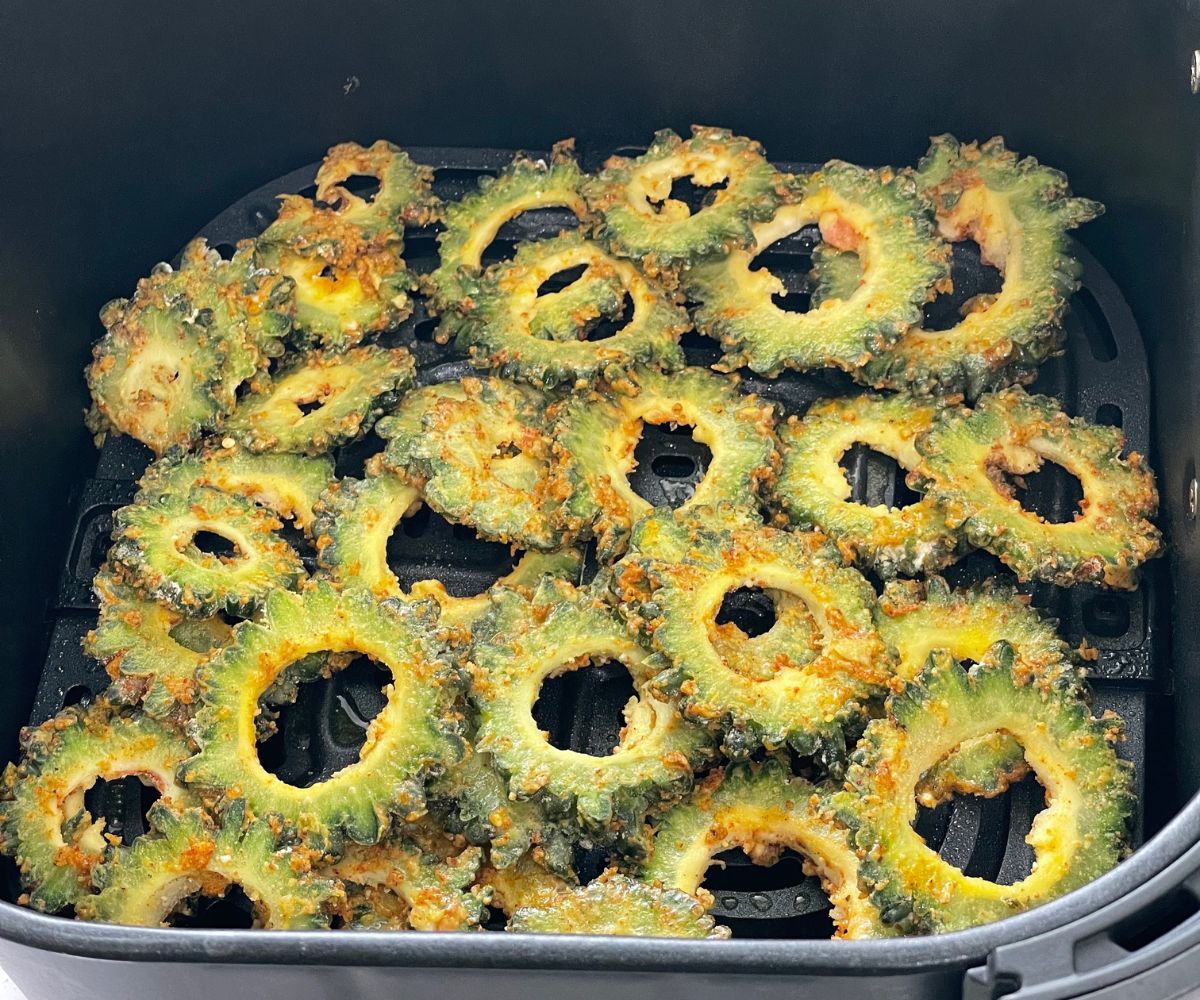 Air fryer basket is with karela slices.