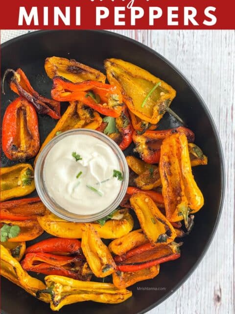 Close up of air fryer roasted mini peppers and dip on the plate.